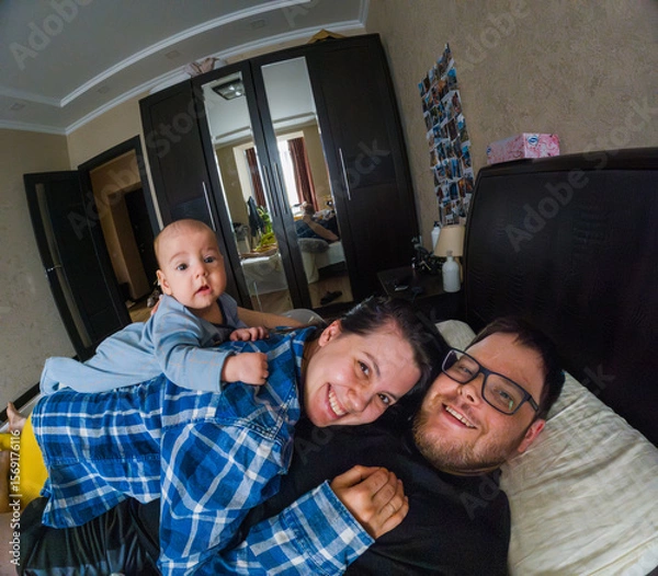 Fototapeta Happy Family Relaxing in Bedroom