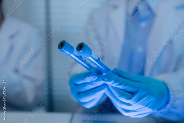 Fototapeta when in a lab, scientists wear lab coats, rubber gloves, and safety goggles, two chemists are testing chemicals in a liquid state, chemists working in a laboratory