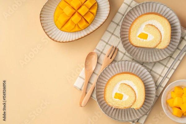 Fototapeta Delicious mango cream Swiss roll cake on plate