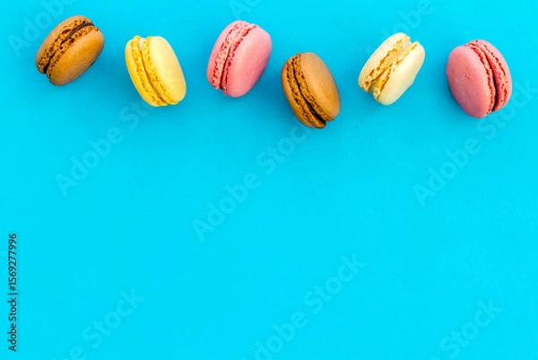 Fototapeta sweet dessert pattern with macarons on blue background flat lay mockup