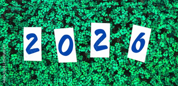 Fototapeta Celebration of a new year with 2026 displayed amidst vibrant green foliage