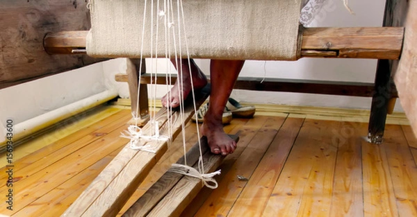 Fototapeta Crafting textiles with traditional loom technique inside a vibrant workshop in the heart of a cultural village