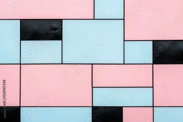 Fototapeta Geometric composition of a modern wall featuring pastel pink, light blue, and black tiles, creating a visually appealing pattern