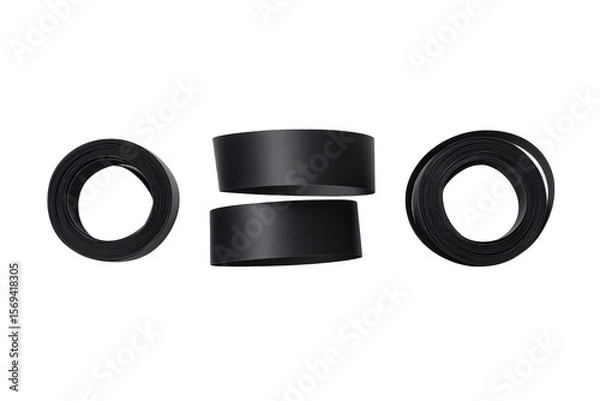 Obraz Three black tire-like objects, stacked and arranged