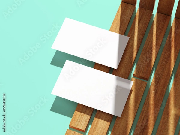 Fototapeta Minimalistic business card resting on a wooden surface with shadows.
