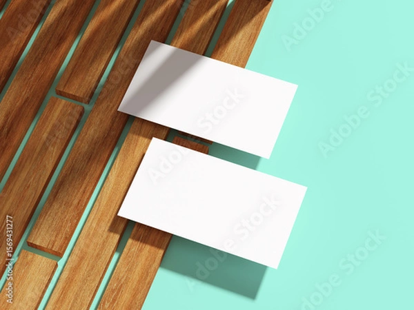 Fototapeta A white business card placed diagonally on wooden planks with flat backdrop.