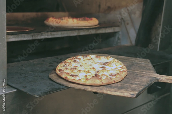 Fototapeta pizza comes from oven