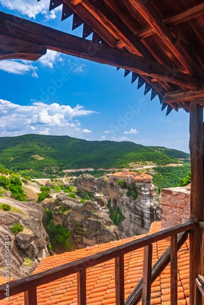Fototapeta View from wooden balcony overlooking dramatic cliffside monasteries in Meteora Greece
