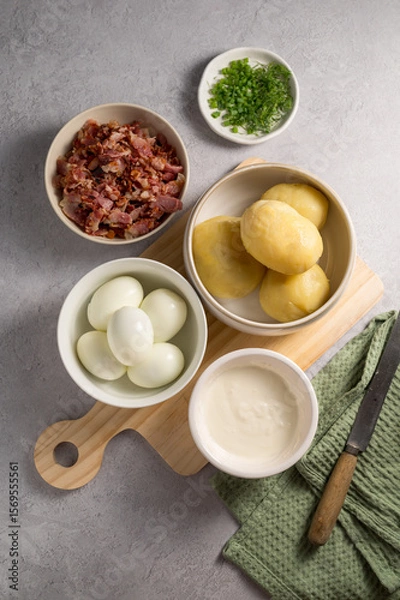 Fototapeta Cooking egg potato salad with bacon and fresh herbs in a plate