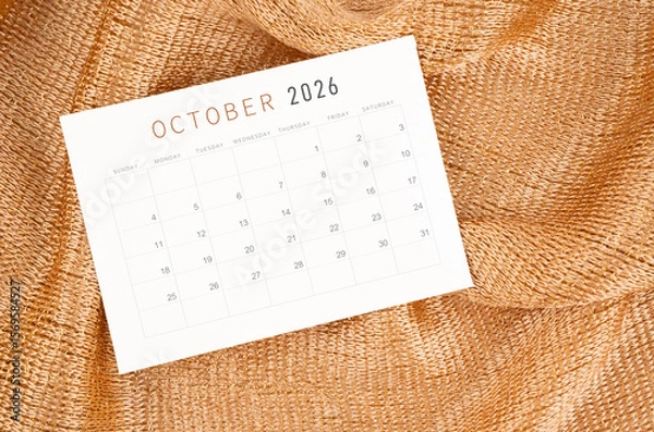 Fototapeta October 2026 calendar card on golden color textile background.