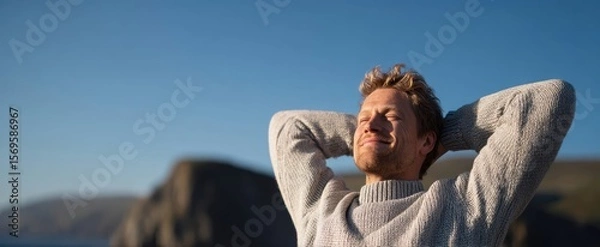 Fototapeta The man enjoying the serene beauty of nature and the warmth of sunlight.