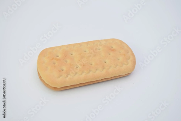 Obraz Light-tan sandwich cookie with small holes.