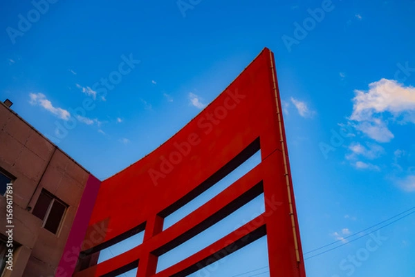 Fototapeta Geometric shapes of modern building facades with blue sky spaces