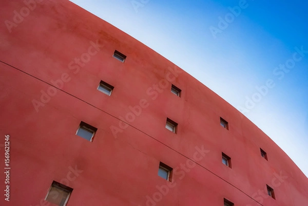 Fototapeta Geometric shapes of modern building facades with blue sky spaces
