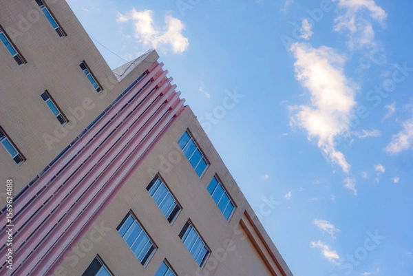 Fototapeta Geometric shapes of modern building facades with blue sky spaces