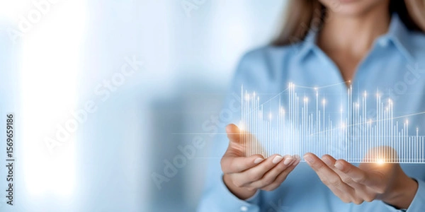 Fototapeta Businesswoman holding a holographic graph visualization, representing data analysis, financial growth, and innovation in a modern corporate environment