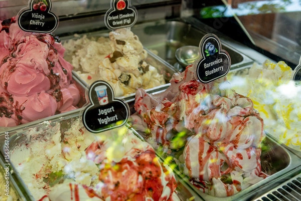 Fototapeta Various Colored Fruit Delicious Ice Cream in Containers on Display Case for Sale