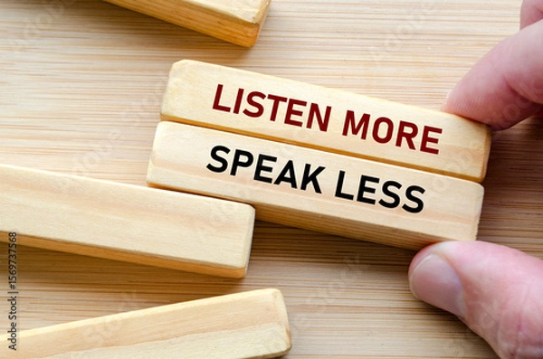 Fototapeta Listen more and speak less phrase on wooden blocks, a reminder to practice thoughtful listening before reacting, especially in leadership and teamwork