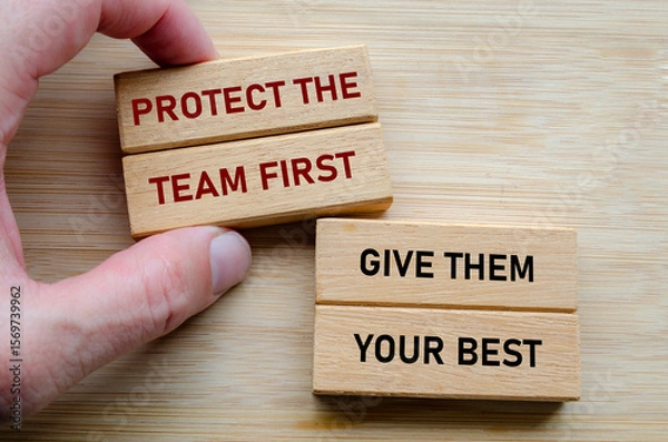 Fototapeta Protect the team first and give them your best text on wooden blocks, reinforcing the idea that effective leadership involves serving and uplifting others consistently