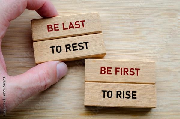 Fototapeta Be the last phrase on wooden blocks in hand, symbolizing selfless leadership where leaders ensure the team is taken care of before themselves