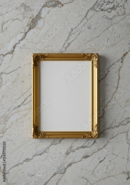 Fototapeta A simple golden picture frame with ornate corners, empty and resting on a marble surface.