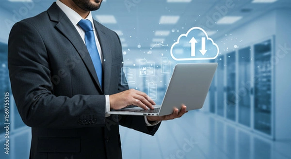 Fototapeta Modern office worker engaging with a laptop, illustrating efficient remote data access and cloud services.