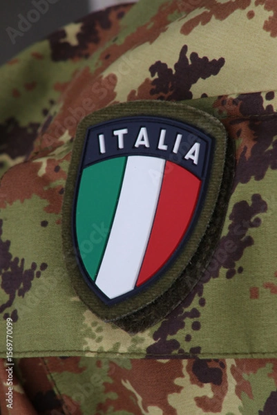 Fototapeta Shield symbol of the Italian flag on military uniform background, Italy