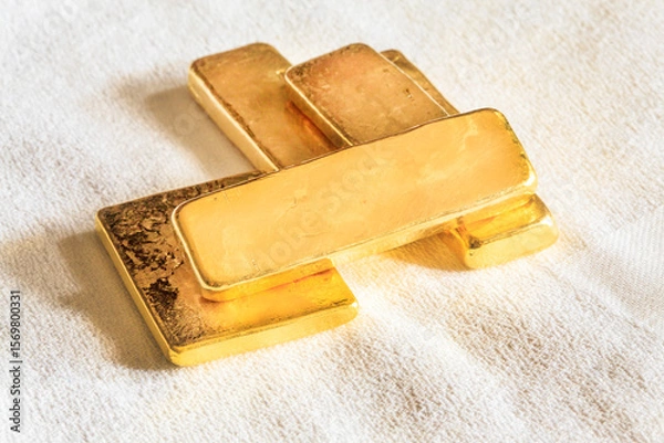 Fototapeta Pure ingots gold on the white background