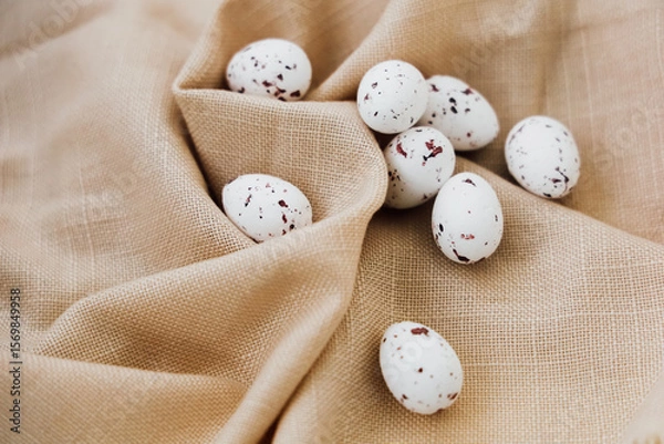 Obraz Quail eggs arranged on light fabric with speckles and natural textures in a cozy setting