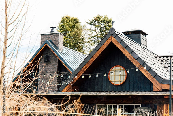 Obraz Charming mountain home with unique architecture and exterior details in a serene landscape