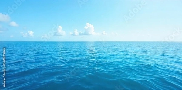 Fototapeta Serene Ocean Surface Vast Blue Water Under a Clear Sky, Perfect for Travel, Nature, and Environmental Projects. Ideal for Websites and Desktop Backgrounds.