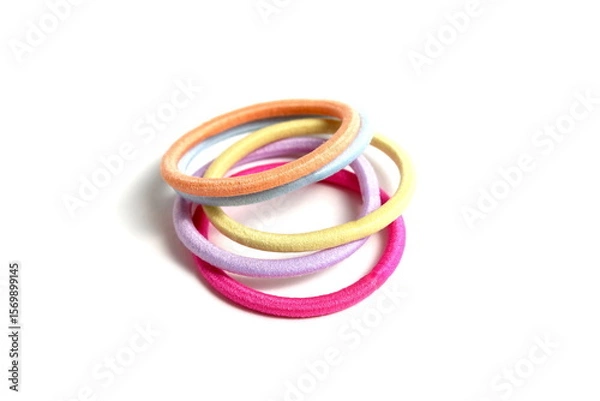 Obraz There are many hair ties lying on a white background.