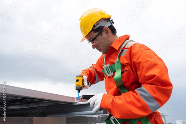 Obraz Solar panel rooftop, Rooftop solar power. Engineer or technicians maintaining and repairing solar power systems on rooftop of building. Male engineer install solar cell on rooftop