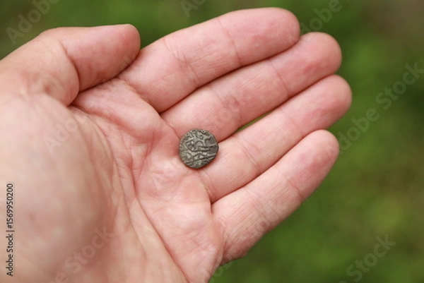 Fototapeta Small medieval coin of India in hand
