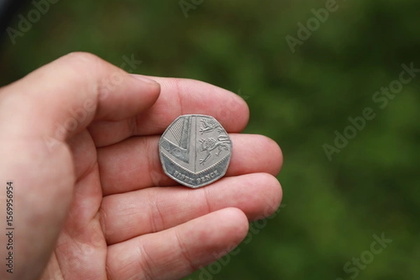 Fototapeta Coin of Great Britain in hand