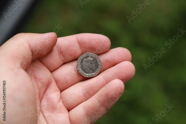 Fototapeta Coin of Great Britain in hand