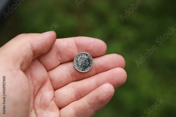 Fototapeta Coin of Great Britain in hand