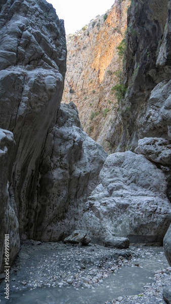 Fototapeta Stream in deepest narrow stone canyon Saklikent in national park in Mugla Province in southwestern Turkey. Vertical image