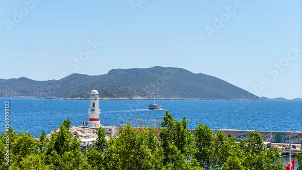 Fototapeta View of lighthouse and yachts in marina of town Kas, Turkey. Active recreation and boat trips in Mediterranean Sea