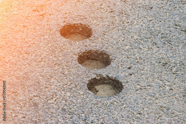 Fototapeta inspection round holes in asphalt left after checking the thickness and quality of the asphalt