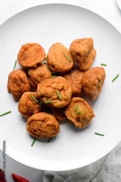 Obraz Overhead view of Akara on a white plate, top view of nigerian akara fried beans cake on a plate