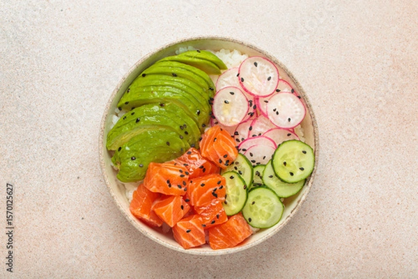 Obraz Poke bowl, a traditional hawaiian dish with diced raw salmon, avocado, vegetables served with rice and vegetables, a healthy meal on light background