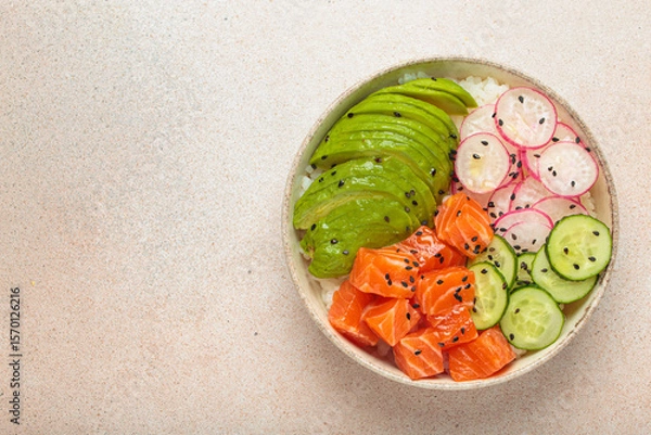 Obraz Poke bowl, a traditional hawaiian dish with diced raw salmon, avocado, vegetables served with rice and vegetables, a healthy meal on light background, copy space