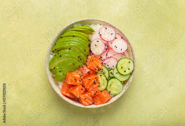 Obraz Poke bowl, a traditional hawaiian dish with diced raw salmon, avocado, vegetables served with rice and vegetables, a healthy meal on green background