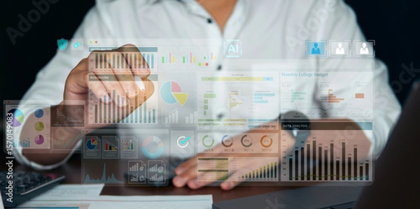 Fototapeta Hand interacting with a transparent virtual screen showing business analytics and financial data charts. Futuristic workplace with digital transformation technology in use.