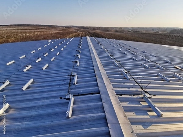 Fototapeta Structure on the house roof for solar panels with installed power optimizers