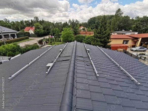 Fototapeta The structure on the house's roofing felt for installing solar panels, with microinverters also installed