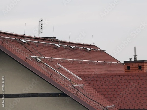 Fototapeta The structure on the house's roofing felt for installing solar panels, with microinverters also installed