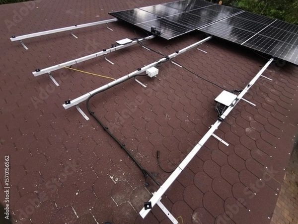 Fototapeta The structure on the house's roofing felt for installing solar panels, with microinverters also installed