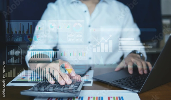 Fototapeta Close-up of hands working on a laptop with colorful virtual data dashboards overlay, showing charts, analytics, and KPI performance metrics. Modern workplace and technology concept.